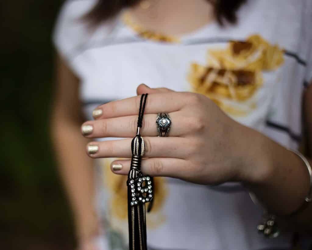 close up hands and tassel graduation